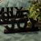 Signage: Family, Love, Joy & Faux Plant