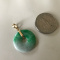 Beautiful light green jade and gold circle pendant.